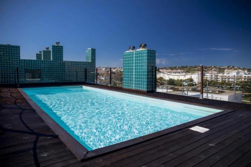 a swimming pool on the roof of a building at B03 - Luxury 2 Bed near Lagos Marina in Lagos