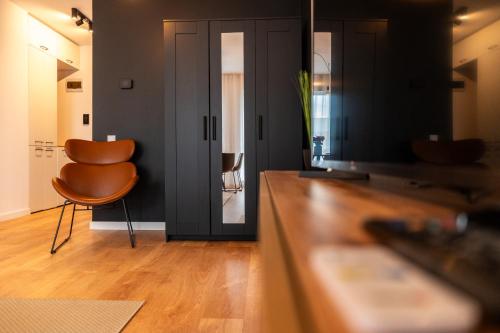 a living room with a table and a chair at BCB Aparts Wood Nest in Floreşti