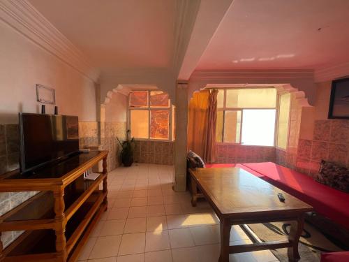 a living room with a couch and a table at Robscal Apartments by Surf Times in Taghazout