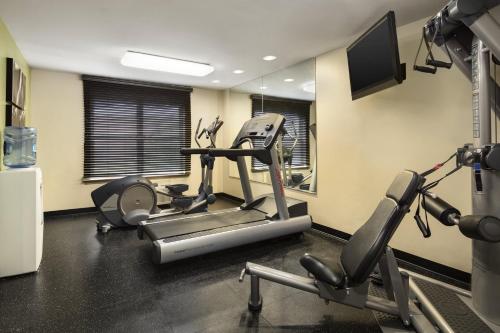 a gym with two exercise bikes and a television at Country Inn & Suites by Radisson, Washington Dulles International Airport, VA in Sterling