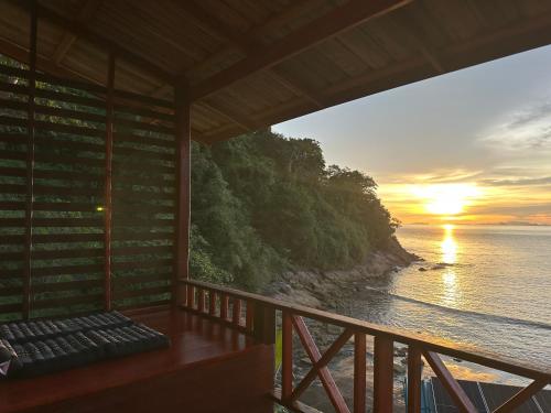 a view of the ocean from the balcony of a house at Mama's Bungalows Koh Chang Ranong in Koh Chang Ranong