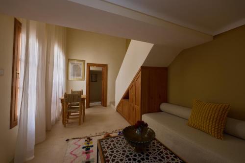 Una sala de estar con un sofá y una ventana. en Riad Al Muhandiz Peaceful Duplex Suites near Jemaa El Fna, en Marrakech