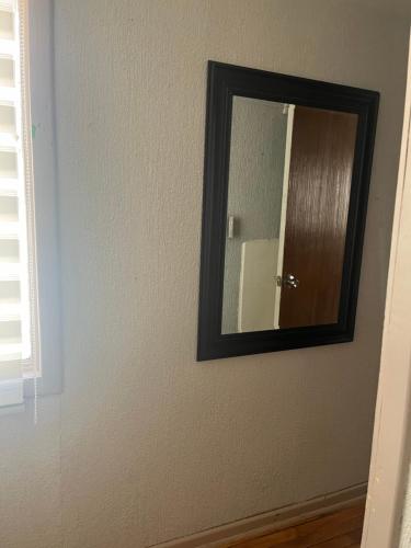 a mirror on a wall in a room at Hostal Constitución in Chillán
