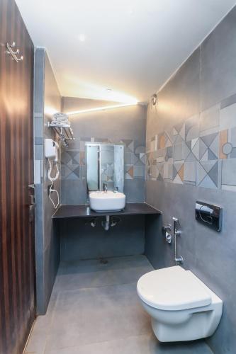 a bathroom with a white toilet and a sink at Hotel O Delhi in Karol Bagh Delhi - A budget Friendly Hotel in New Delhi