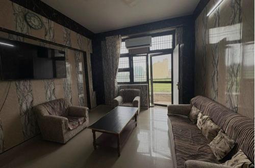 ein Wohnzimmer mit Sofa und Tisch in der Unterkunft Awaraj Home Stay in Agra