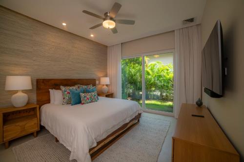a bedroom with a bed and a large window at Casa Ohana 5 bdrs ocean view in Los Suenos in La Mona