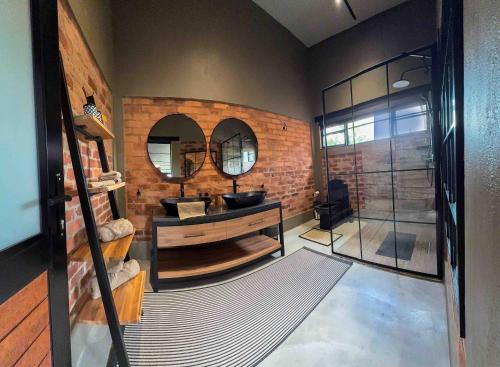 a bathroom with a sink and a mirror at vanDijksRus Farm in The Waterberg Biosphere