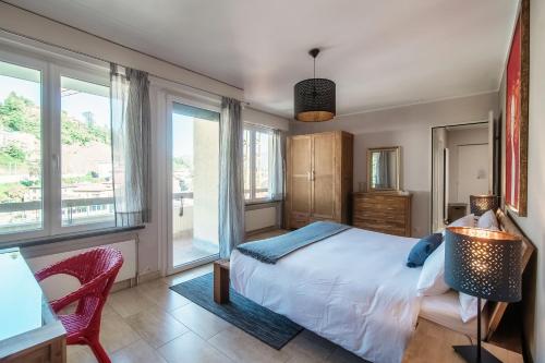 a bedroom with a bed and some windows at Terrazza Paradiso by Quokka 360 - Spacious Design Flat with Terrace in Paradiso