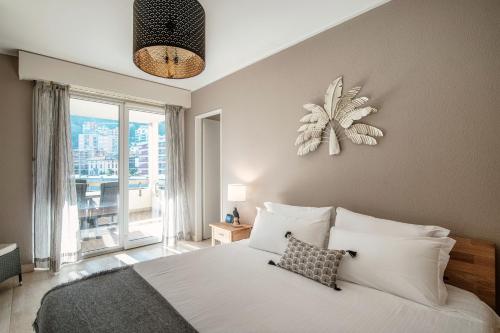 a bedroom with a bed and a large window at Terrazza Paradiso by Quokka 360 - Spacious Design Flat with Terrace in Paradiso
