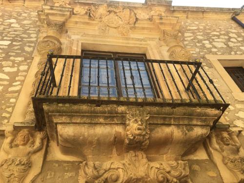 a balcony on the side of a building with a window at Hostal Posada La Panadera in Sepúlveda
