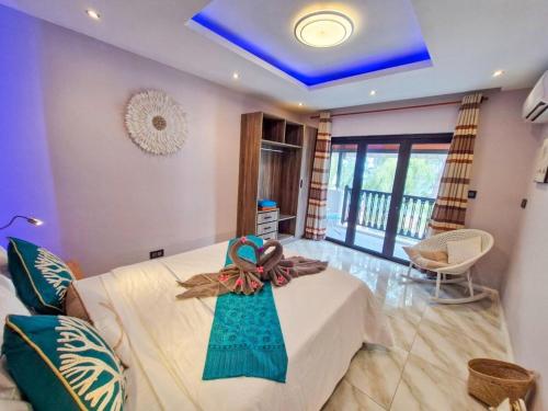 a bedroom with a bed with a bow on it at Blue vibes in Flic-en-Flac