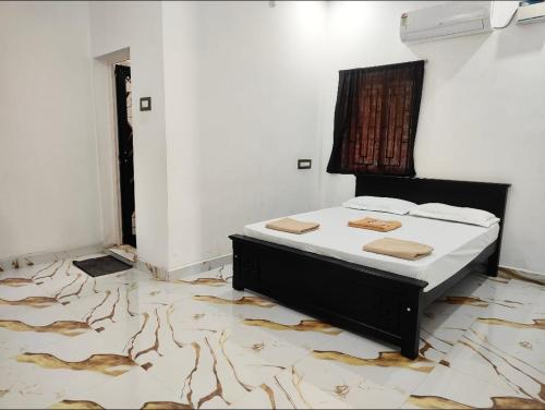 a bedroom with a bed in a room at Coco farm homestay in Rāmeswaram
