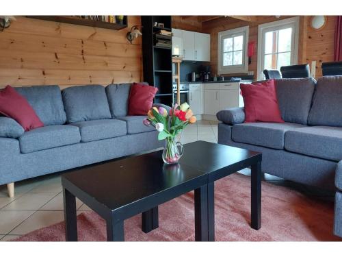 a living room with a vase of flowers on a table at Ferienhaus, Wissinghausen in Medebach