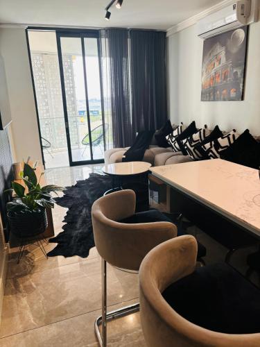 a living room with couches and tables and chairs at Thango Res Ellipse Waterfall. in Midrand