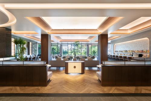 a lobby of a hotel with couches and a bar at Okinawa Harborview Hotel in Naha