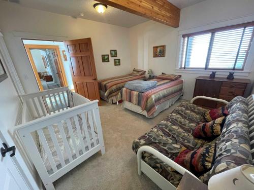ボイジーにあるSpectacular Views and Rural Setting Close to Boiseのベッドルーム(ベッド2台、ベビーベッド1台付)