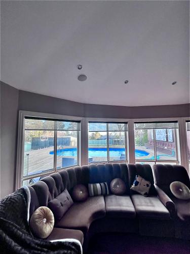 a living room with a large couch in front of windows at 'Wallan luxury house in Wallan