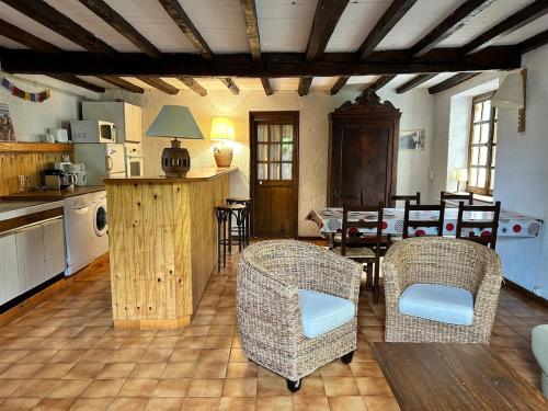 a kitchen and dining room with chairs and a table at La Petite Rocaille in Soulom