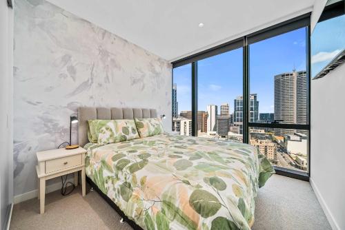 a bedroom with a bed and a large window at Luxury Perth CBD Apartment with Pool & Gym in Perth