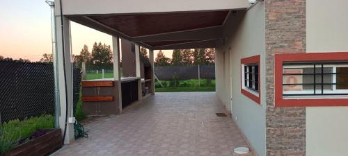 a building with an open garage with a brick wall at Comoda quinta en El Pato in El Pato