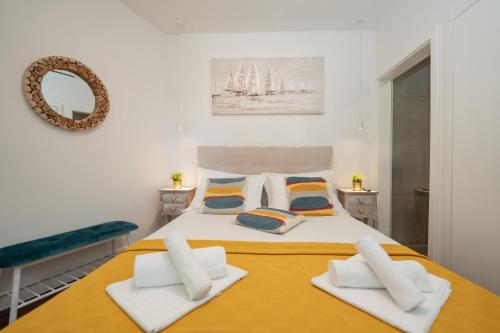 a bedroom with a large bed with two pillows at Villa Picholine in Jakišnica