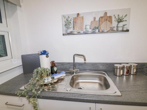 a kitchen counter with a sink in a kitchen at Two in Peterborough