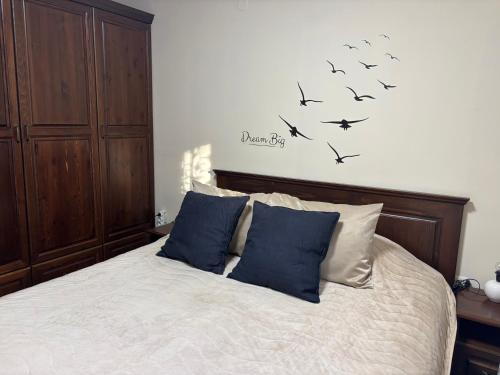 a bedroom with a bed with birds on the wall at Emily Pirin Golf in Razlog