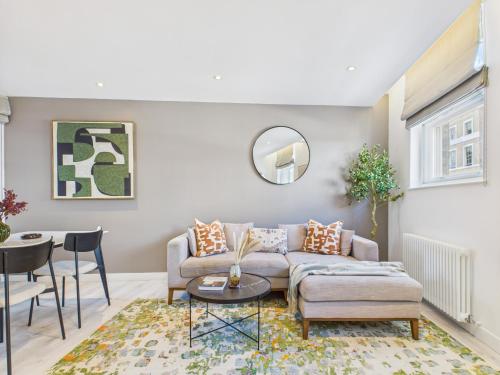 a living room with a couch and a table at Be London - Borough Market Residences in London
