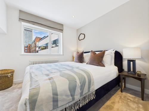a white bedroom with a bed and a window at Be London - Borough Market Residences in London