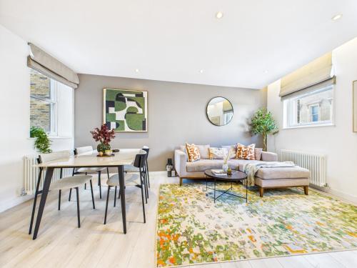 a living room with a couch and a table at Be London - Borough Market Residences in London