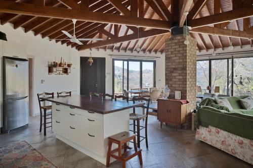 a kitchen and living room with a table and chairs at Orama Mountain Villa Farmakas in Nicosia