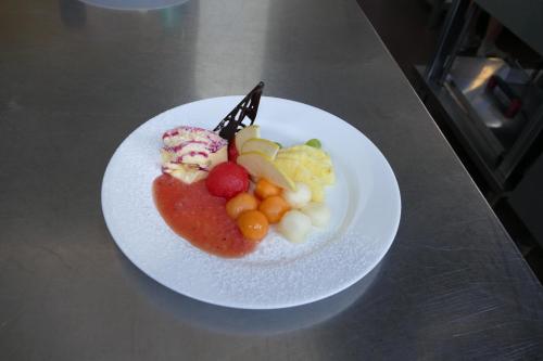 a plate of food with fruit on a table at Hotel L'Ulivo in Mirabella Eclano