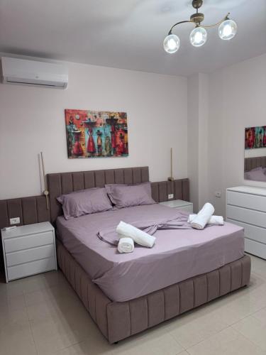 a bedroom with a bed with white towels on it at Star Vollga Luxe Apartment in Durrës