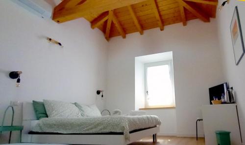 a bedroom with a bed and a window at Adda River Tower Room in Calolziocorte