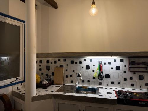 a kitchen with a sink and a counter top at Taco Super Place in Unawatuna