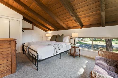 a bedroom with a large bed and a window at 2 Landrise in Sunriver