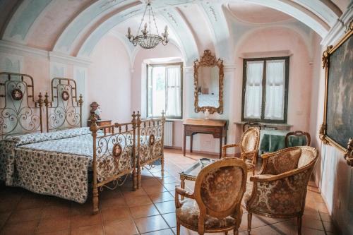 a bedroom with a bed and a table and chairs at Cascina Bringin in Mondovì