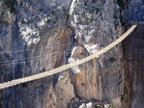 a suspension bridge on the side of a mountain at Casa Rural las Rosas de Benaojan in Benaoján