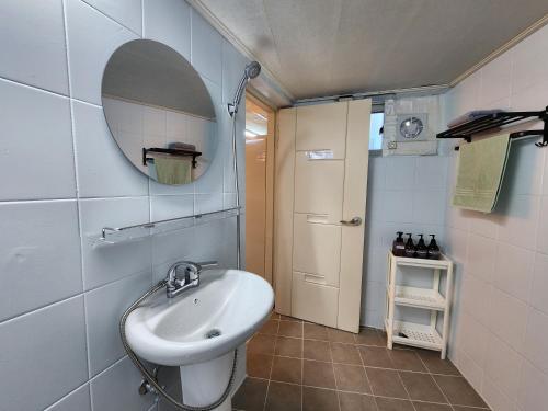 a small bathroom with a sink and a mirror at Rosemary in Seoul