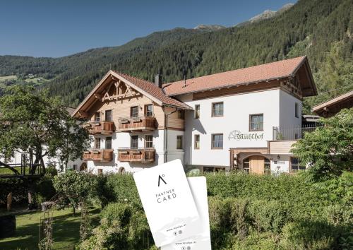 a hotel in the mountains with a sign in front of it at MYALPS Mühlhof inklusive Sauna in Oetz