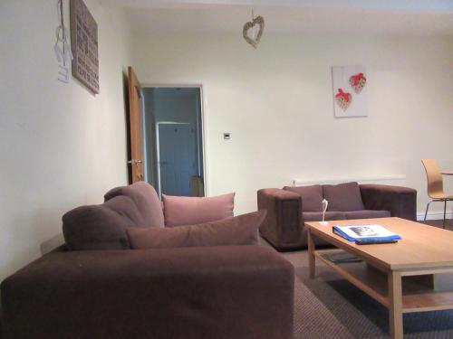 a living room with two couches and a coffee table at No 8 - LARGE 2 BED NEAR SEFTON PARK AND LARK LANE in Liverpool