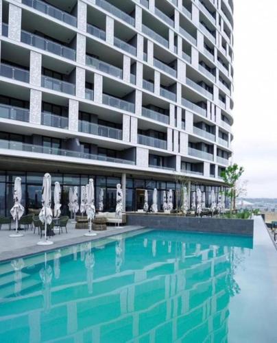 a large apartment building with a swimming pool at Thango Res Ellipse Waterfall. in Midrand