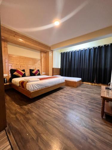 a bedroom with a large bed in a room at GS COTTAGE BED and BREAKFAST walking distance from Mall Road in Shimla