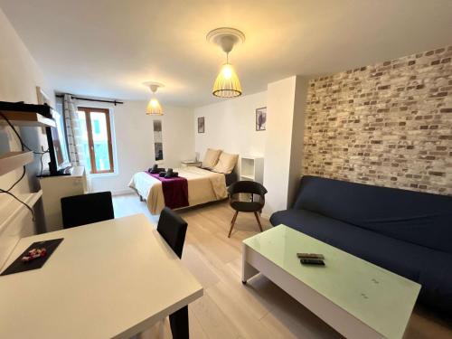 a room with a couch and a bed and a table at City Center - Duplex Studio - Close to RER in Saint-Germain-en-Laye