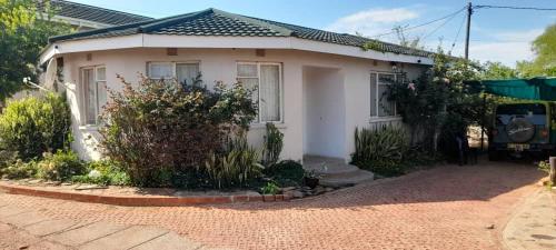 a small white house with at The Oval House in Otse