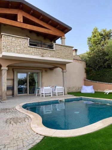 a swimming pool in front of a house at Villa Bellavista Chia in Chia