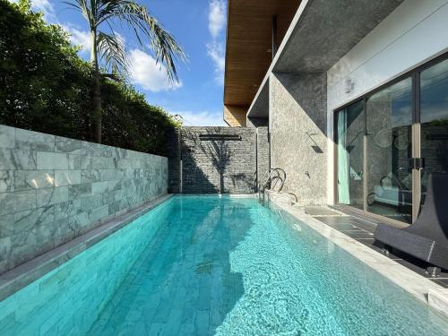 a swimming pool in the backyard of a house at 2 Bedroom Pool Villa Chalong in Chalong