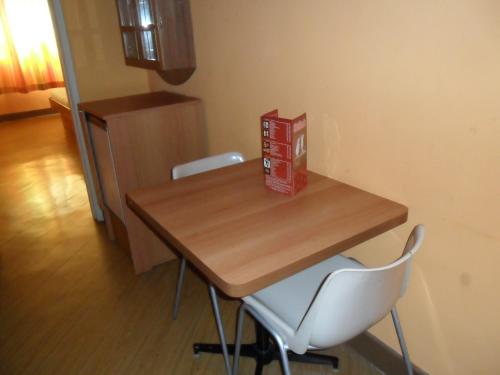 a wooden table with two chairs and a box on it at Jumbo Hotel (Adults Only) in Rio de Janeiro