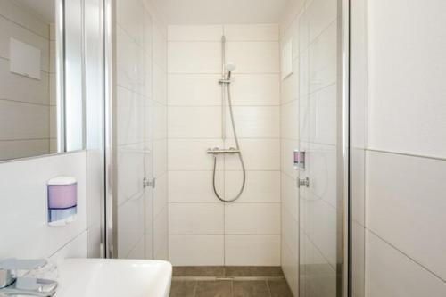 a bathroom with a shower and a sink at Landhaus im Feld in Sankt Michael im Lungau