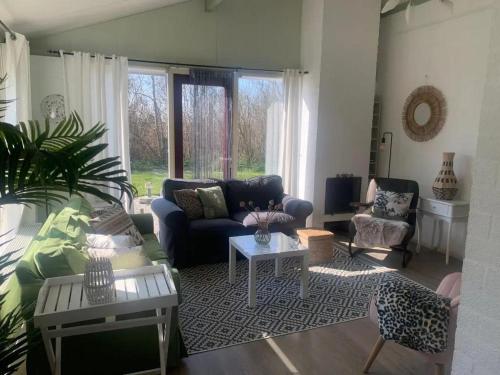 a living room with a couch and a table at Bungalow 049 in Petten
